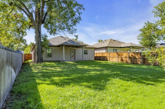 Rear view of property with a fenced backyard and a yard | Image 26