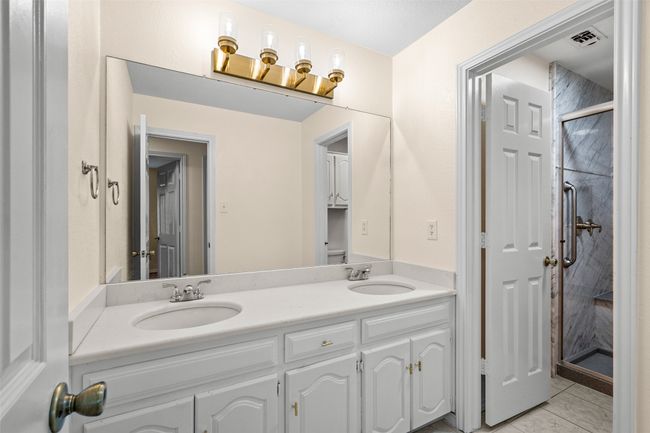 Full bath featuring double vanity and a shower stall | Image 22