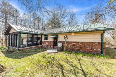 Back of property featuring a sunroom and a lawn | Image 3