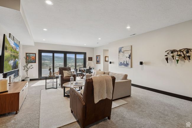 Living room with light carpet, recessed lighting, and a textured ceiling | Image 45