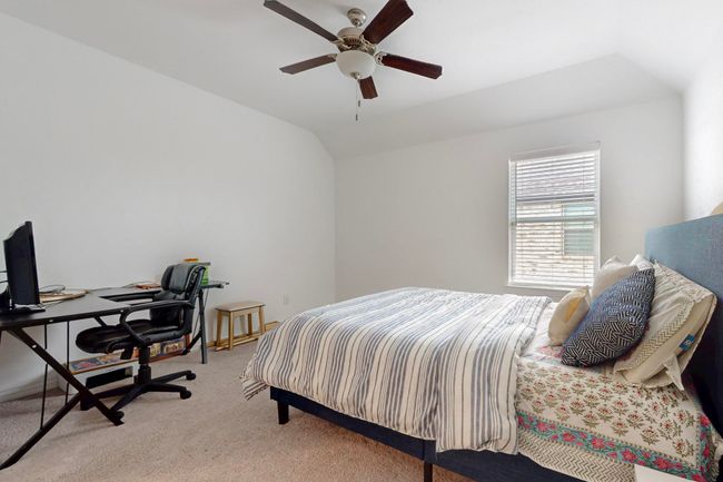 Bedroom featuring carpet floors, a ceiling fan, and vaulted ceiling | Image 38