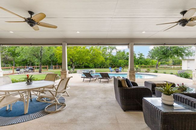 With plenty of room for seating and sun shades, this covered patio offers a comfortable retreat from the Texas sun. | Image 30