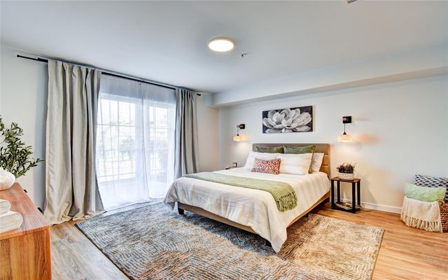 Bedroom with baseboards and wood finished floors | Image 13
