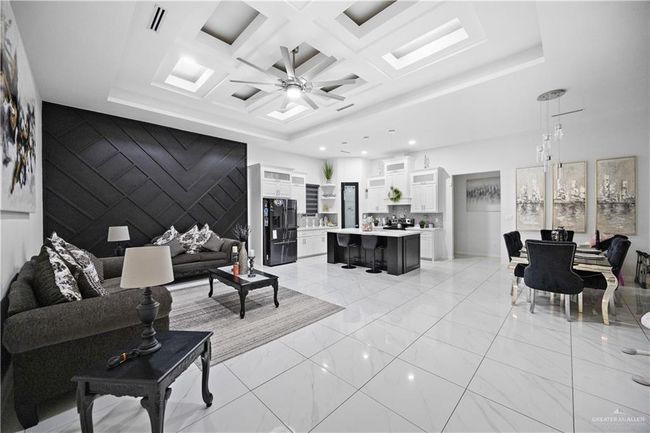 Living room with a ceiling fan, light marble finish floors, recessed lighting, and coffered ceiling | Image 17