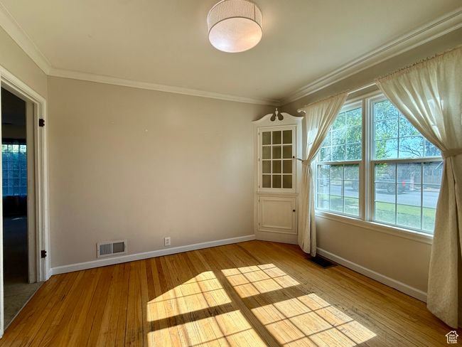 Unfurnished room featuring light wood-style flooring, baseboards, and crown molding | Image 18