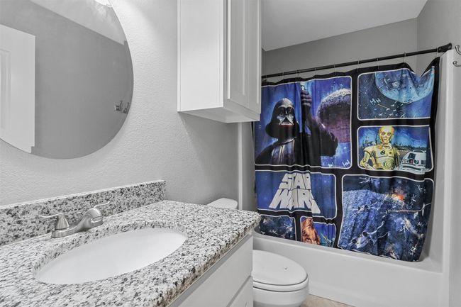 Full bath with toilet, vanity, and shower / bathtub combination with curtain | Image 17