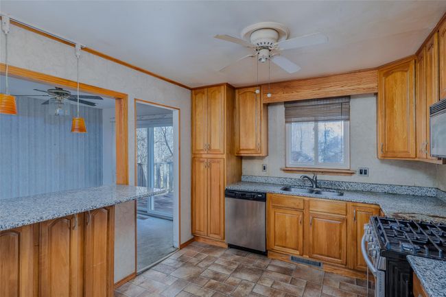 Kitchen featuring appliances with stainless steel finishes, a wealth of natural light, visible vents, and a sink | Image 11