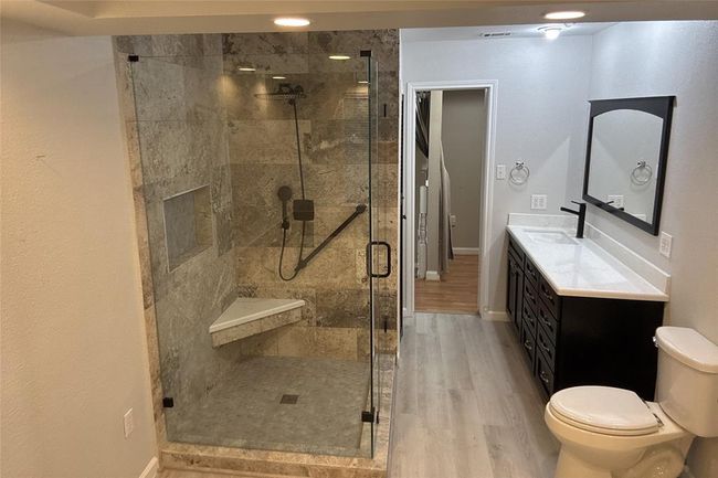 Experience the elegance of the newly remodeled primary bath, seamlessly accessible from the bedroom. | Image 9