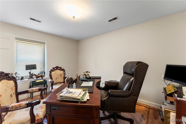 Home office featuring visible vents, baseboards, and wood finished floors | Image 38