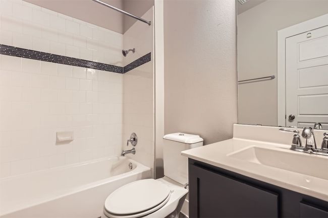 Bathroom with vanity and bathing tub / shower combination | Image 21