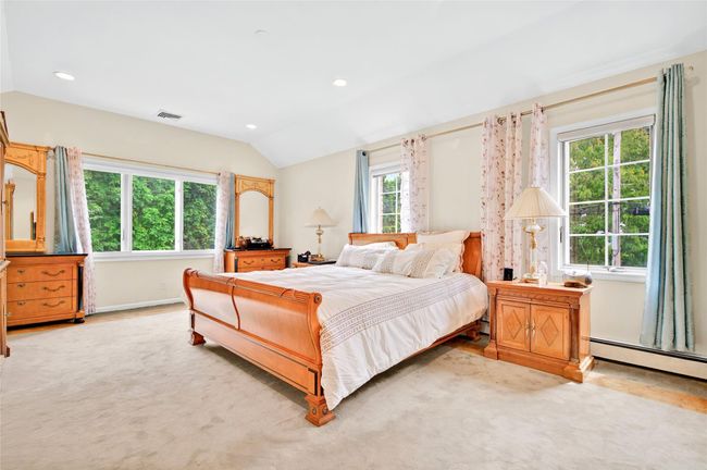 Bedroom with vaulted ceiling, recessed lighting, baseboards, and baseboard heating | Image 27