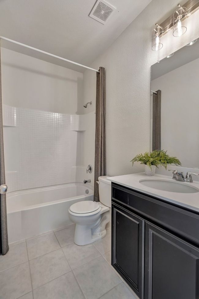 Full bath with vanity, shower / bath combo, and tile patterned floors | Image 22