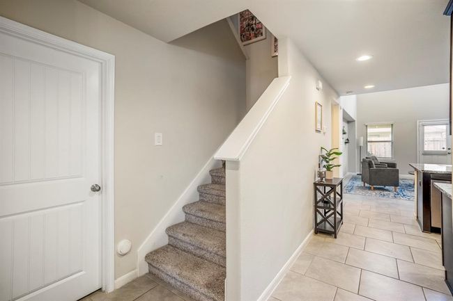The stairs leading to the second floor living of the home. | Image 10