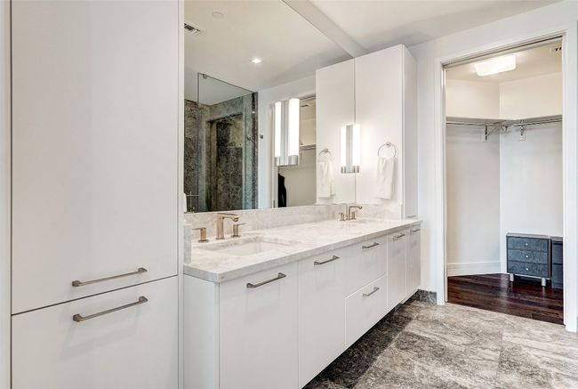 Bathroom with a shower stall, double vanity, a spacious closet, and recessed lighting | Image 17