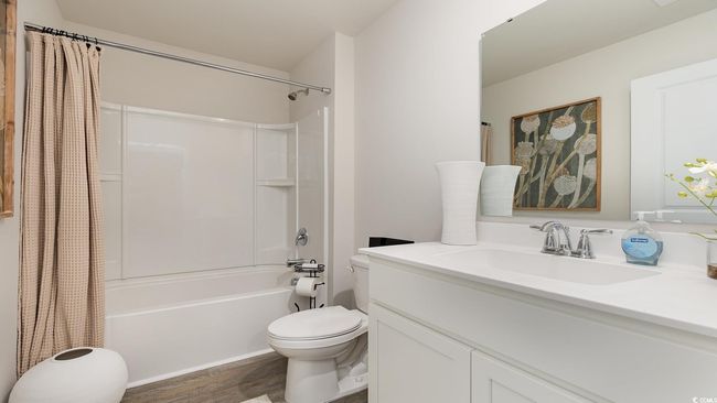 Full bathroom with vanity, toilet, wood finished floors, and shower / tub combo with curtain | Image 21