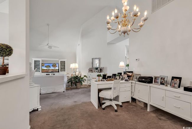 Formal Dining/Office flex space open to Living Room w/high vaulted ceiling, a chandelier, and ceiling fan | Image 11