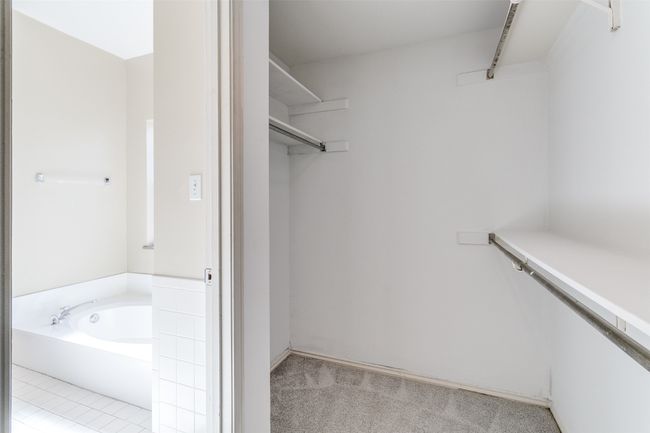 Primary Closet with a small closet nearby that has the stackable Laundry | Image 18