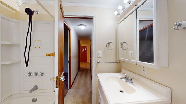 Bathroom with vanity, tiled shower / bath, and ornamental molding | Image 20