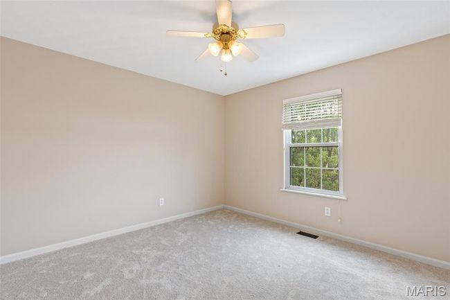 Unfurnished room with carpet floors, baseboards, and ceiling fan | Image 20