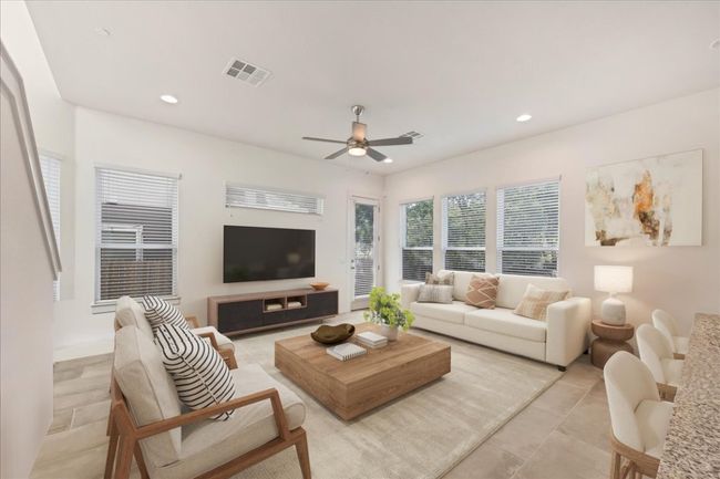 The living room has tons of windows and connects to the kitchen. Virtually staged. | Image 5