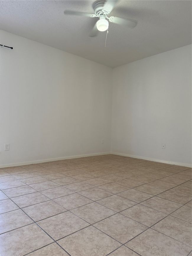 Spare room featuring baseboards and a ceiling fan | Image 11