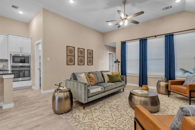 Living area featuring a ceiling fan, recessed lighting, and light wood-style floors | Image 15