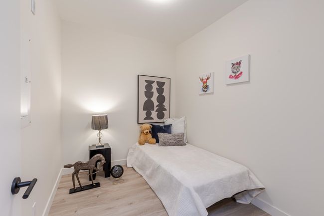 Bedroom with wood finished floors | Image 16