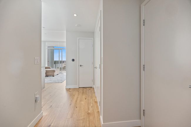 Hallway with recessed lighting, light wood-style flooring, and baseboards | Image 15