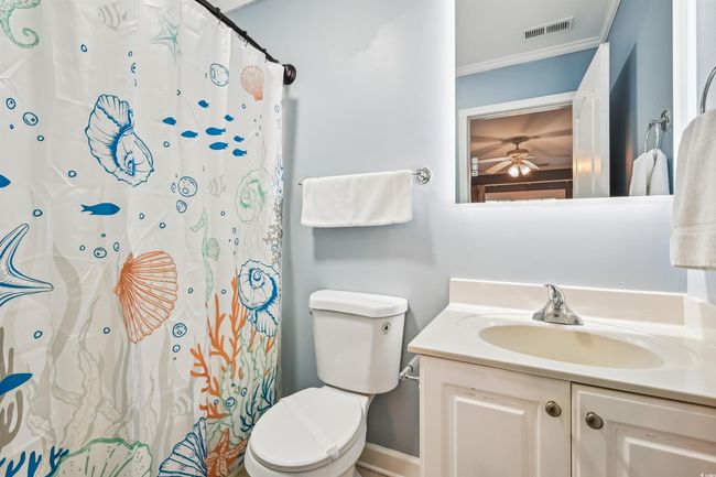 Bathroom featuring vanity, a ceiling fan, ornamental molding, and a shower with shower curtain | Image 28