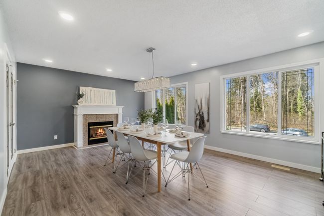 Dining area with a fireplace, baseboards, and wood finished floors | Image 10