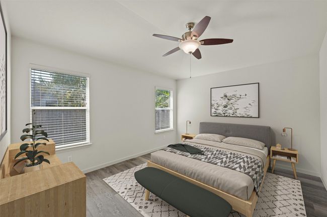 Bedroom with ceiling fan, baseboards, and wood finished floors | Image 16