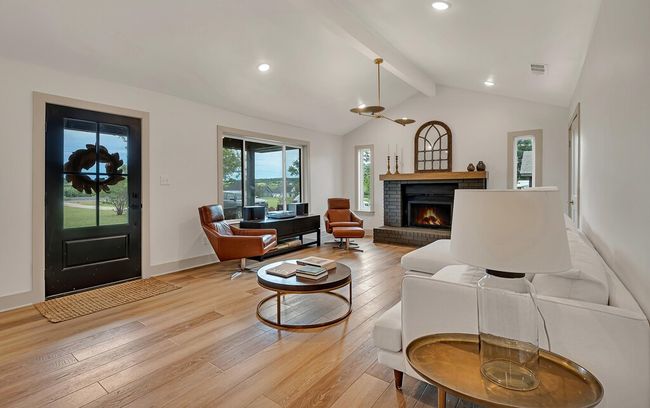 Living room featuring light wood-type flooring, recessed lighting, and a brick fireplace | Image 8
