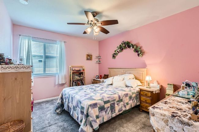 Carpeted bedroom with ceiling fan and baseboards | Image 17