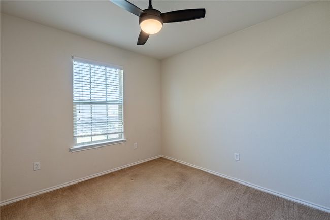 Empty room with light colored carpet and ceiling fan | Image 17