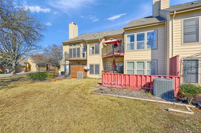 Rear view of property with central AC, a chimney, and a yard | Image 29