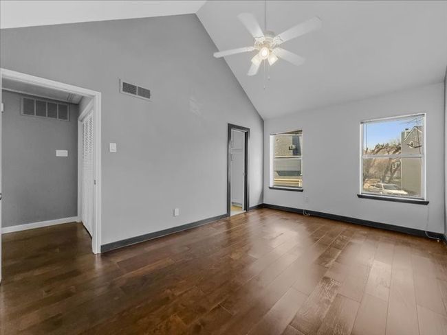 Upstairs bedroom with high vaulted ceiling, dark hardwood / wood-style floors, and ceiling fan | Image 15