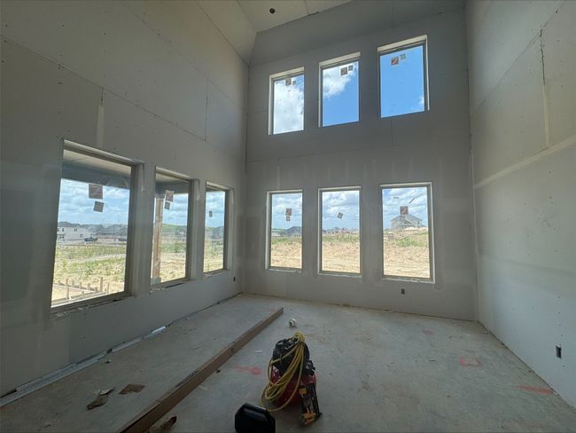 Unfurnished room featuring a high ceiling | Image 7