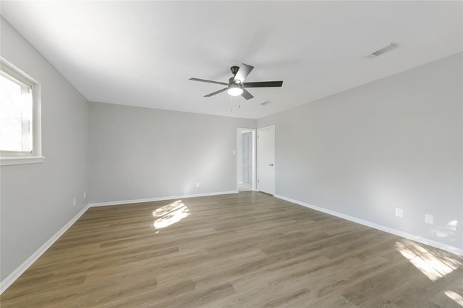 Primary bedroom showing door to primary bath room & door to the hall | Image 19