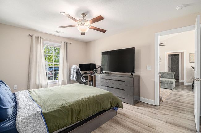 Bedroom featuring wood finished floors, baseboards, and ceiling fan | Image 10