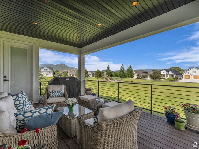 Wooden deck with a residential view, an outdoor living space, and a lawn | Image 28