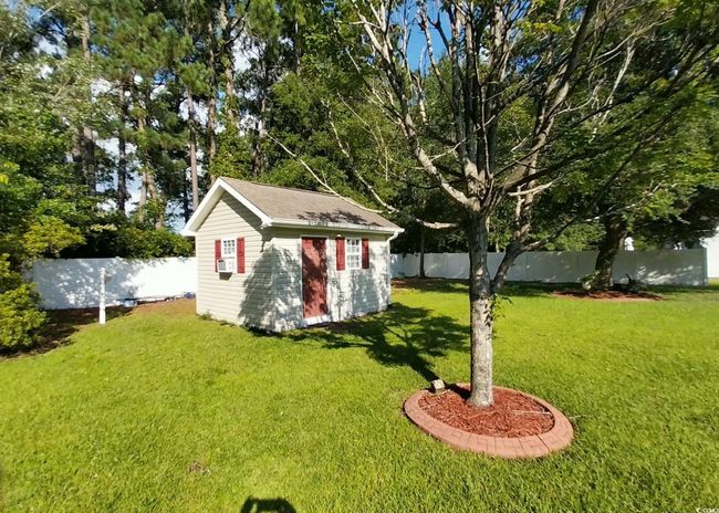 Fenced backyard featuring an outdoor structure | Image 14