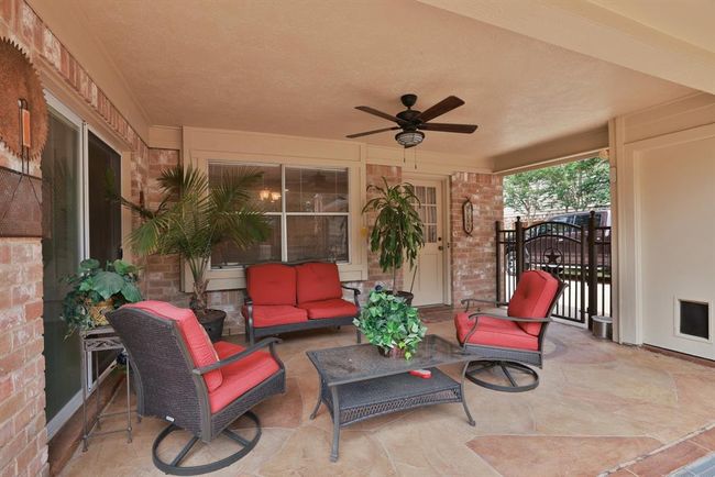 The covered back patio is the perfect place to relax and unwind with a cold beverage in the evenings. | Image 36