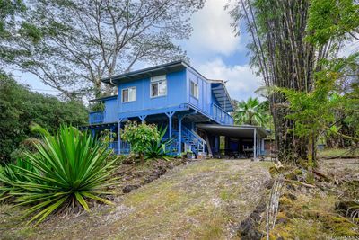 Stairs leads to separate entrance of second floor front door entrance and outdoor storage shed. | Image 1