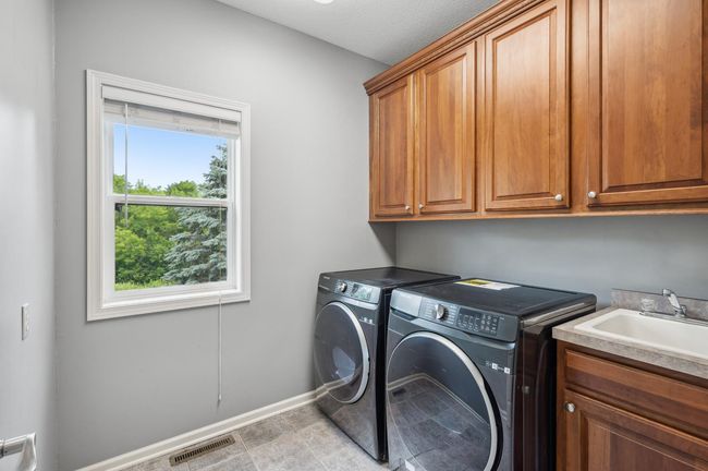 Bright and airy laundry room - right by garage so easy to toss in dirty football gear! | Image 34