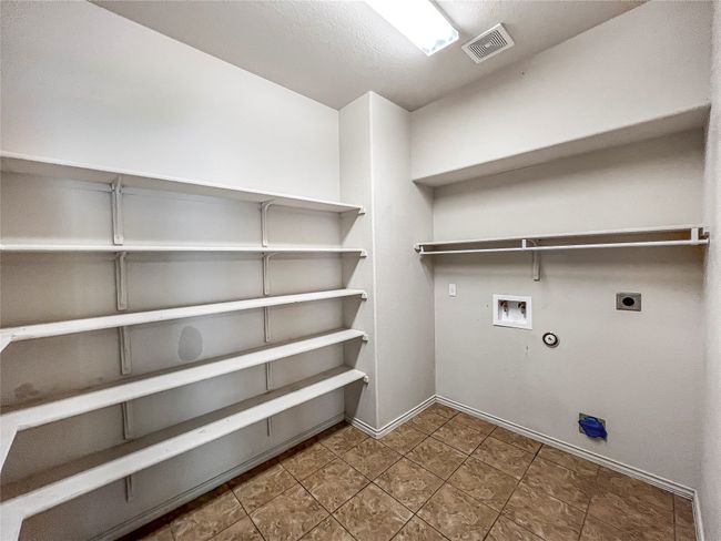 Laundry room featuring gas dryer hookup, electric dryer hookup, washer hookup, and tile patterned floors | Image 10