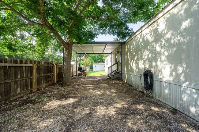 View of yard featuring entry steps and an attached carport | Image 8