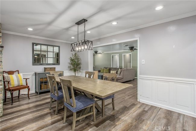 The open floor plan offers a view of the family room, and dining area. | Image 10