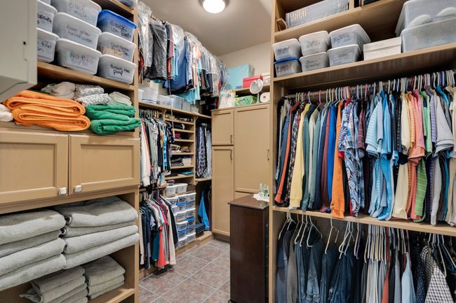 HUGE Walk in closet featuring custom cabinets and safe | Image 23