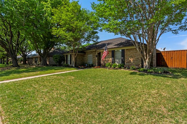 Single story home with a front lawn, fence, and brick siding | Image 37