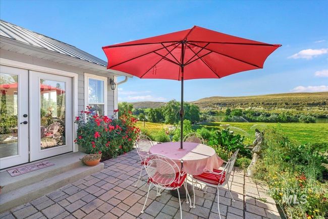 Patio, with view across the river and French doors into the sunroom. | Image 5